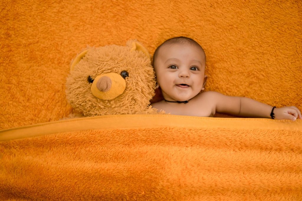 happy-baby-lying-on-bed